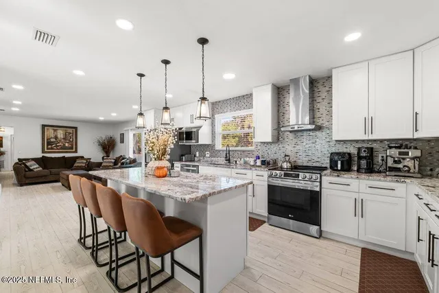 a bathroom with a granite countertop shower sink and mirror