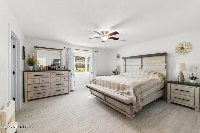 a bathroom with a granite countertop sink a toilet and mirror