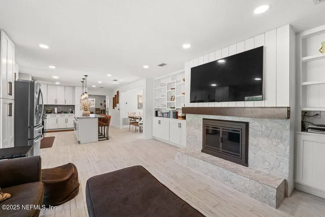 a living room with furniture and a fireplace