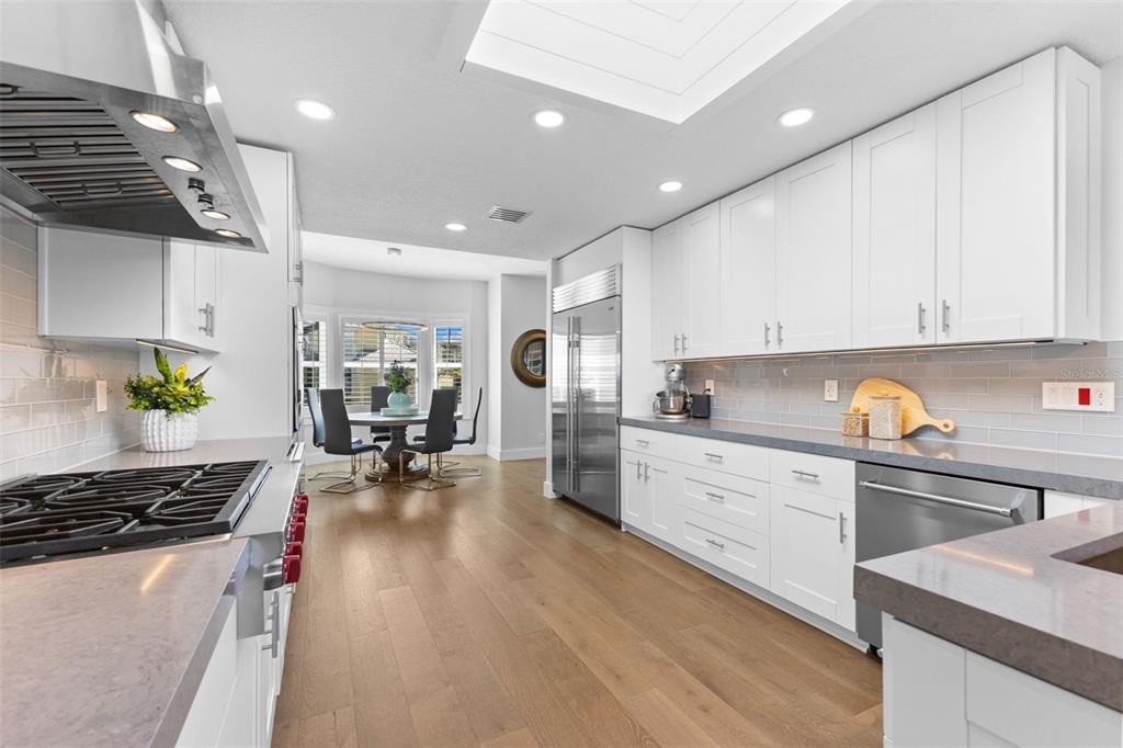 850 Bay Point Drive Madeira Beach, FL 33708 - Photo 15 of 59 a kitchen that has a lot of cabinets a sink and appliances in it