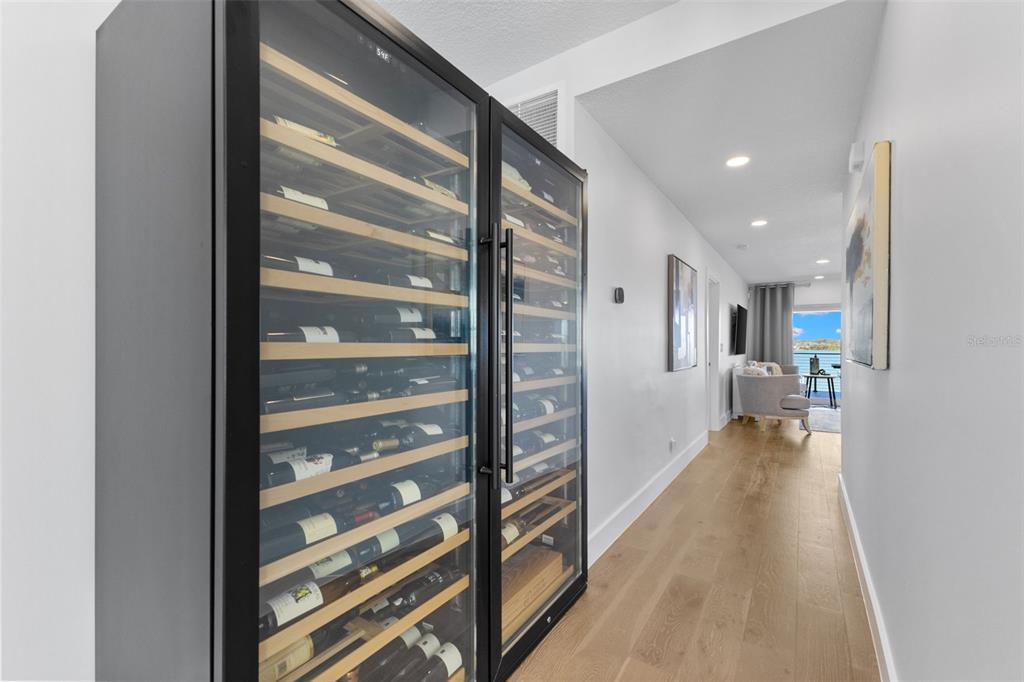 850 Bay Point Drive Madeira Beach, FL 33708 - Photo 17 of 59 a view of a hallway with wooden floor and furniture