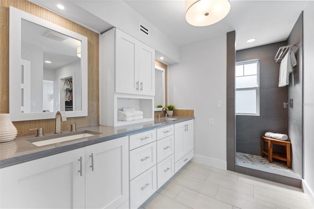 850 Bay Point Drive Madeira Beach, FL 33708 - Photo 21 of 59 a spacious bathroom with double sink and a mirror