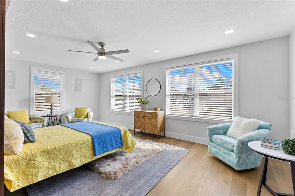 850 Bay Point Drive Madeira Beach, FL 33708 - Photo 24 of 59 a spacious bedroom with a bed and a couch