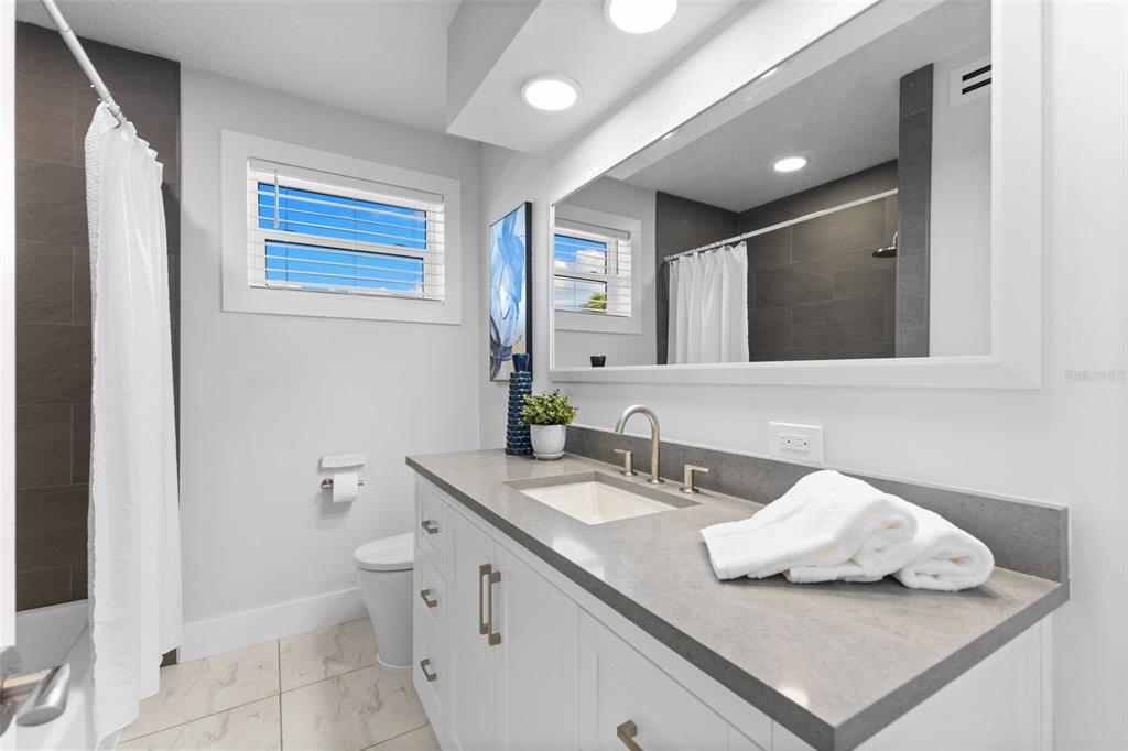 850 Bay Point Drive Madeira Beach, FL 33708 - Photo 26 of 59 a bathroom with a sink and mirror