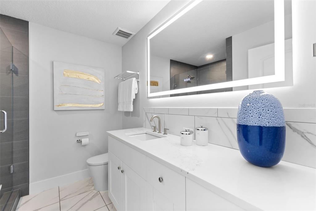 850 Bay Point Drive Madeira Beach, FL 33708 - Photo 29 of 59 a bathroom with a tub sink toilet and mirror