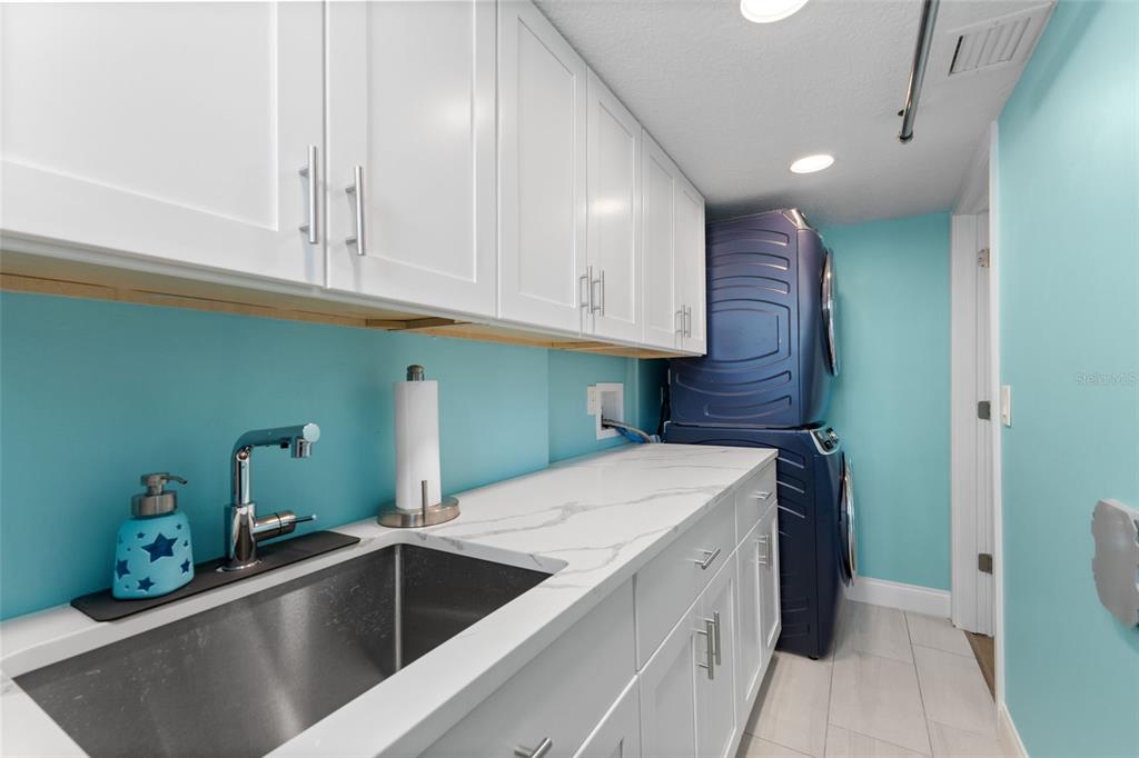 850 Bay Point Drive Madeira Beach, FL 33708 - Photo 38 of 59 a kitchen with a sink and cabinets