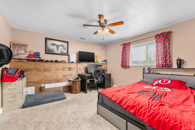 5702 950 North Ogden, UT 84404 - Photo 33 of 36 Carpeted room featuring a ceiling fan with light kit, a window with blinds, and a built-in wood-finish accent wall