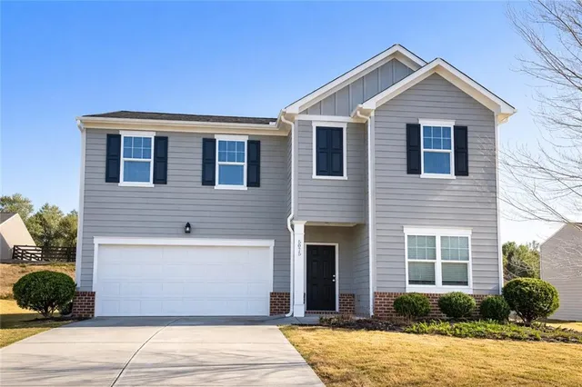 a front view of a house with a yard