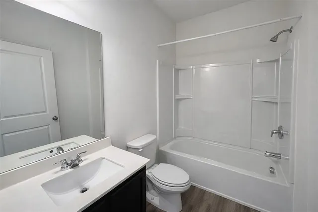 a bathroom with a sink mirror toilet and bathtub