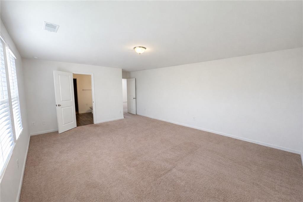 5075 Minnow Lane Cumming, GA 30028 - Photo 16 of 31 an empty room with windows and closet