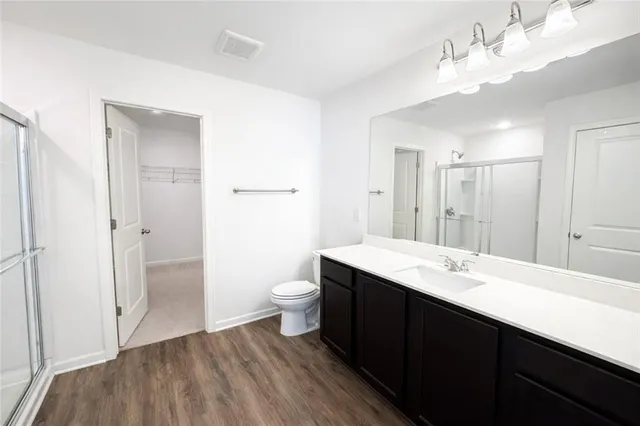 a bathroom with a sink a toilet and a large mirror