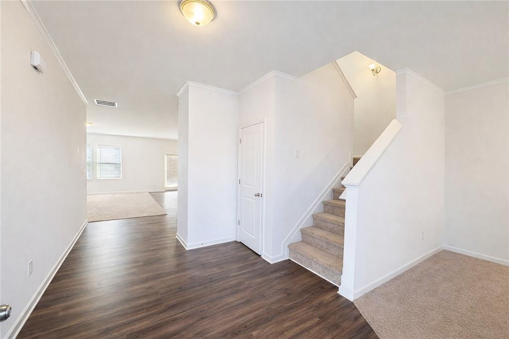 5075 Minnow Lane Cumming, GA 30028 - Photo 2 of 31 a view of a hallway with wooden floor and entryway