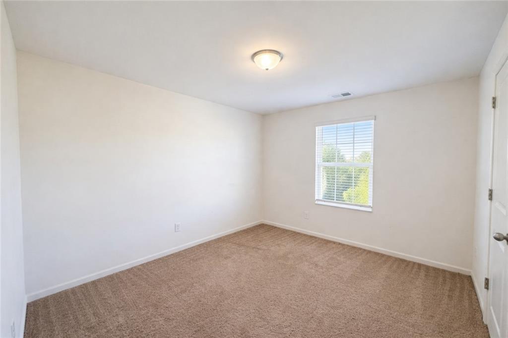 5075 Minnow Lane Cumming, GA 30028 - Photo 21 of 31 an empty room with windows