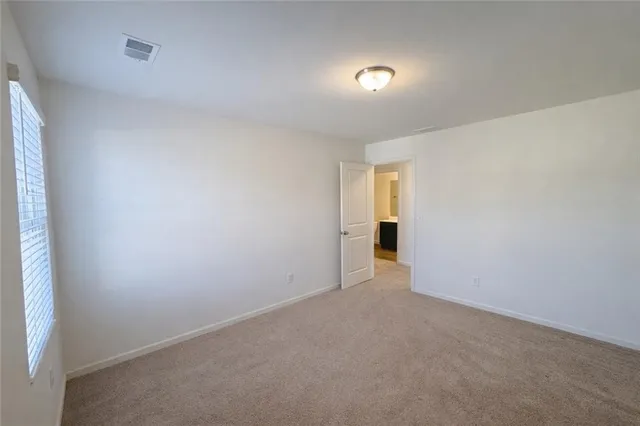 a view of an empty room and a window