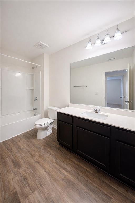 5075 Minnow Lane Cumming, GA 30028 - Photo 24 of 31 a bathroom with a double vanity sink a toilet and a tub