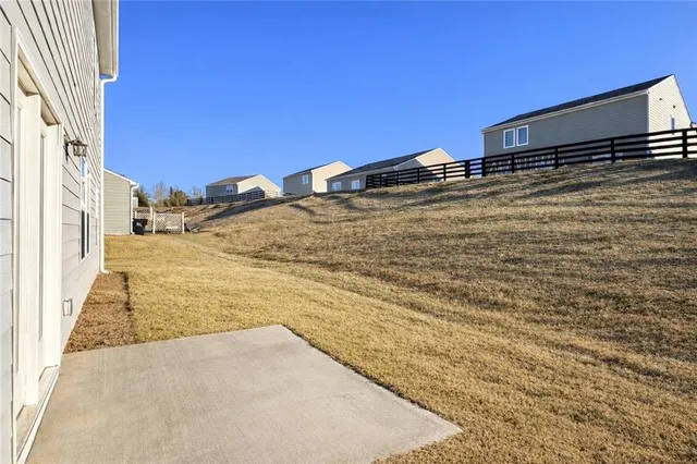 a view of a house with a backyard