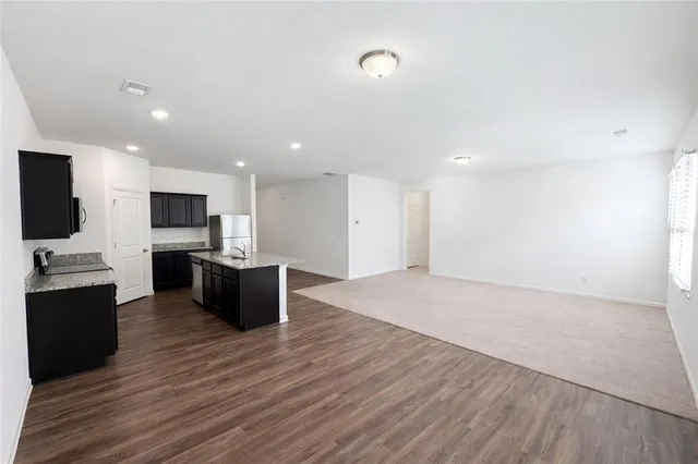 a view of kitchen with cabinets microwave and stove