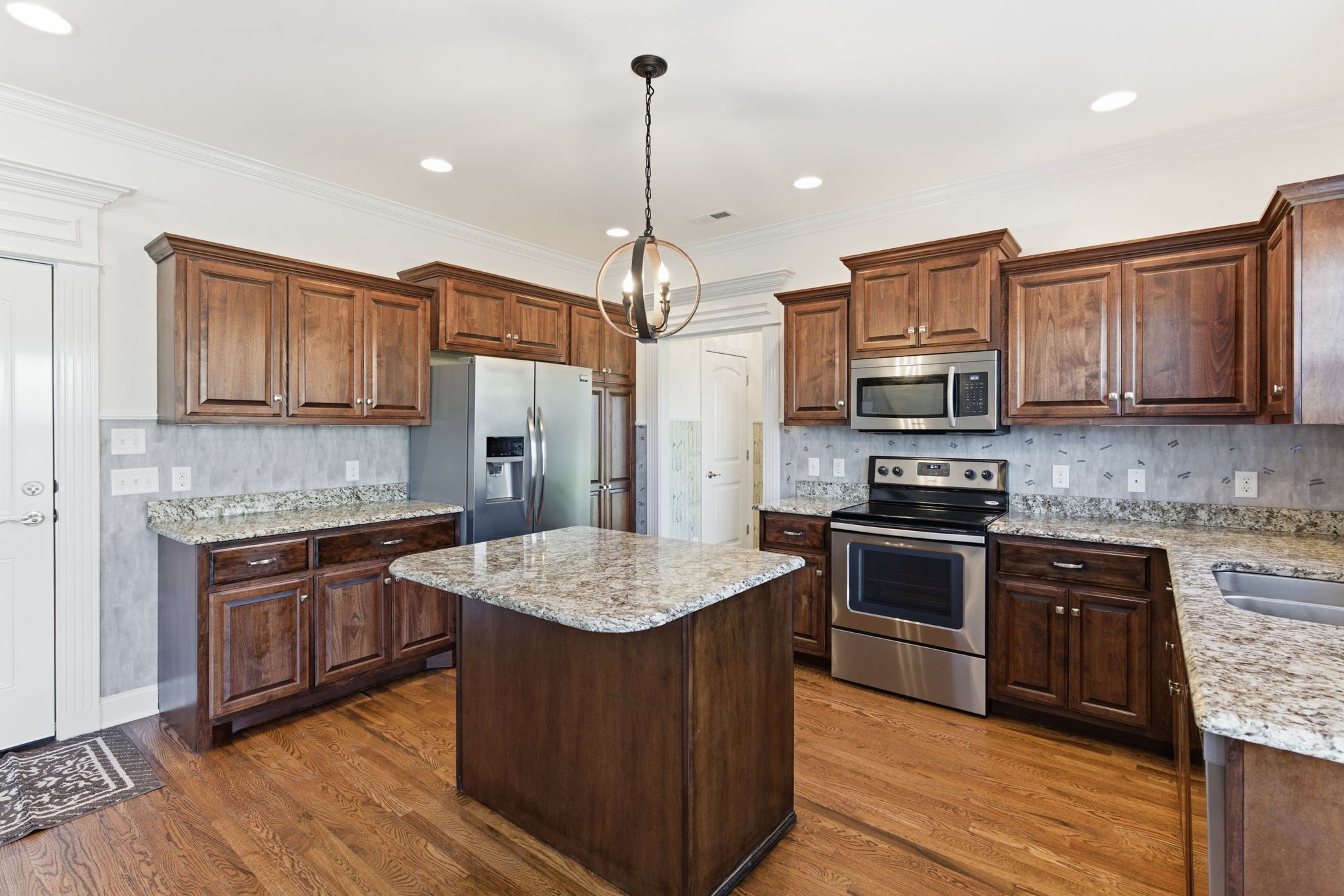1246 Rimrock Road Smyrna, TN 37167 - Photo 11 of 36 a kitchen with stainless steel appliances granite countertop a stove top oven a sink dishwasher and a refrigerator with wooden floor