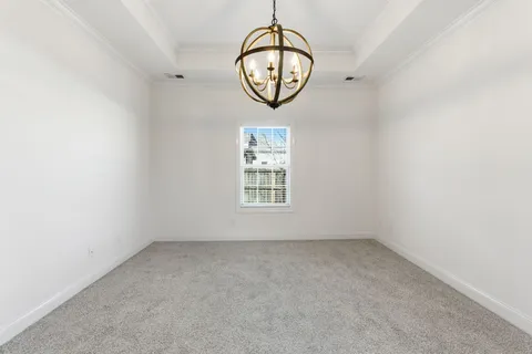 an empty room with a window and a mirror