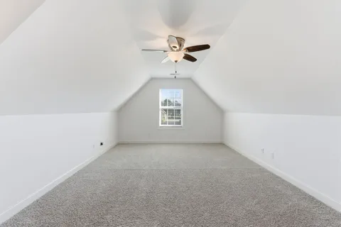 an empty room with a ceiling fan and a window