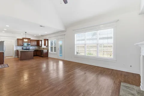 a view of a kitchen with a sink and a large window