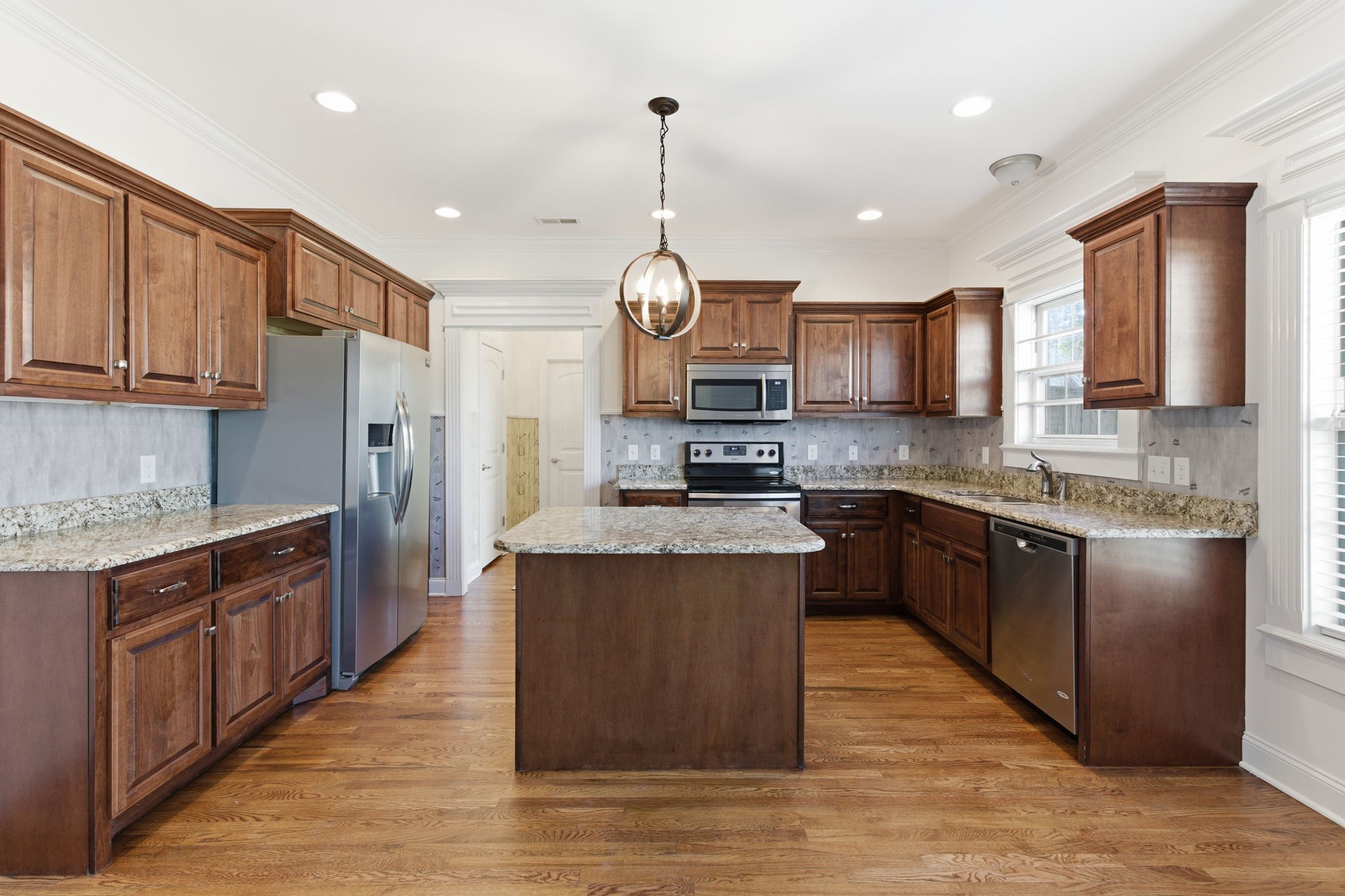 1246 Rimrock Road Smyrna, TN 37167 - Photo 10 of 36 a kitchen with stainless steel appliances granite countertop wooden cabinets a refrigerator a stove a sink and a wooden floors