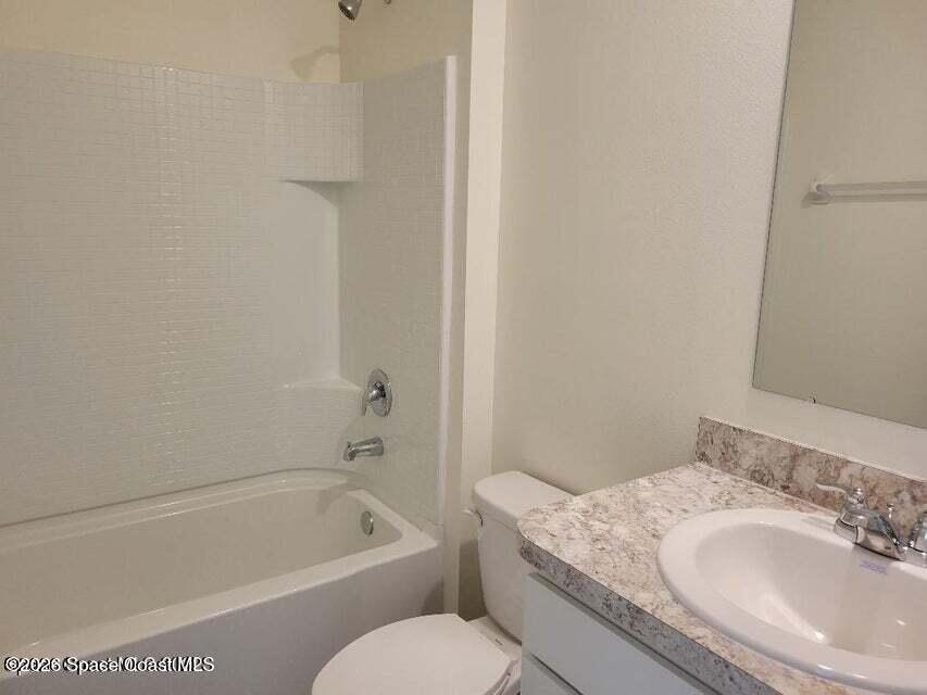 3619 Foggy Mist Road Southeast Palm Bay, FL 32909 - Photo 12 of 18 a bathroom with a granite countertop sink a toilet and bathtub