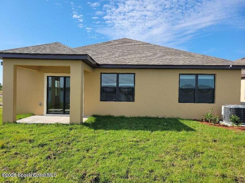 3619 Foggy Mist Road Southeast Palm Bay, FL 32909 - Photo 13 of 18 a front view of a house with a yard