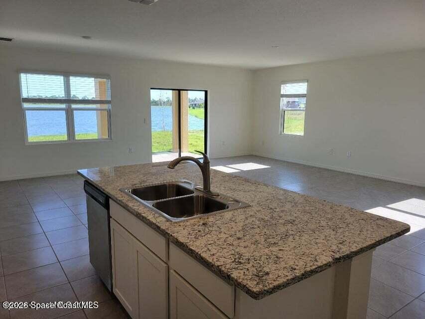 3619 Foggy Mist Road Southeast Palm Bay, FL 32909 - Photo 4 of 18 a kitchen with granite countertop sink and window