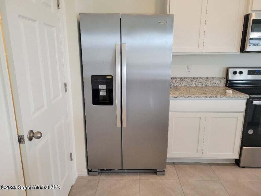 3619 Foggy Mist Road Southeast Palm Bay, FL 32909 - Photo 6 of 18 a utility room with cabinets washer and dryer