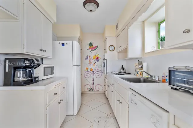 a kitchen with stainless steel appliances a refrigerator sink and cabinets