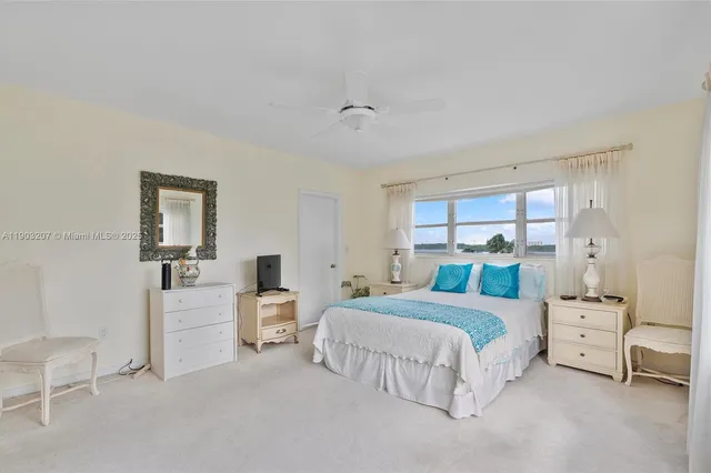 a bedroom with a bed and a lamp