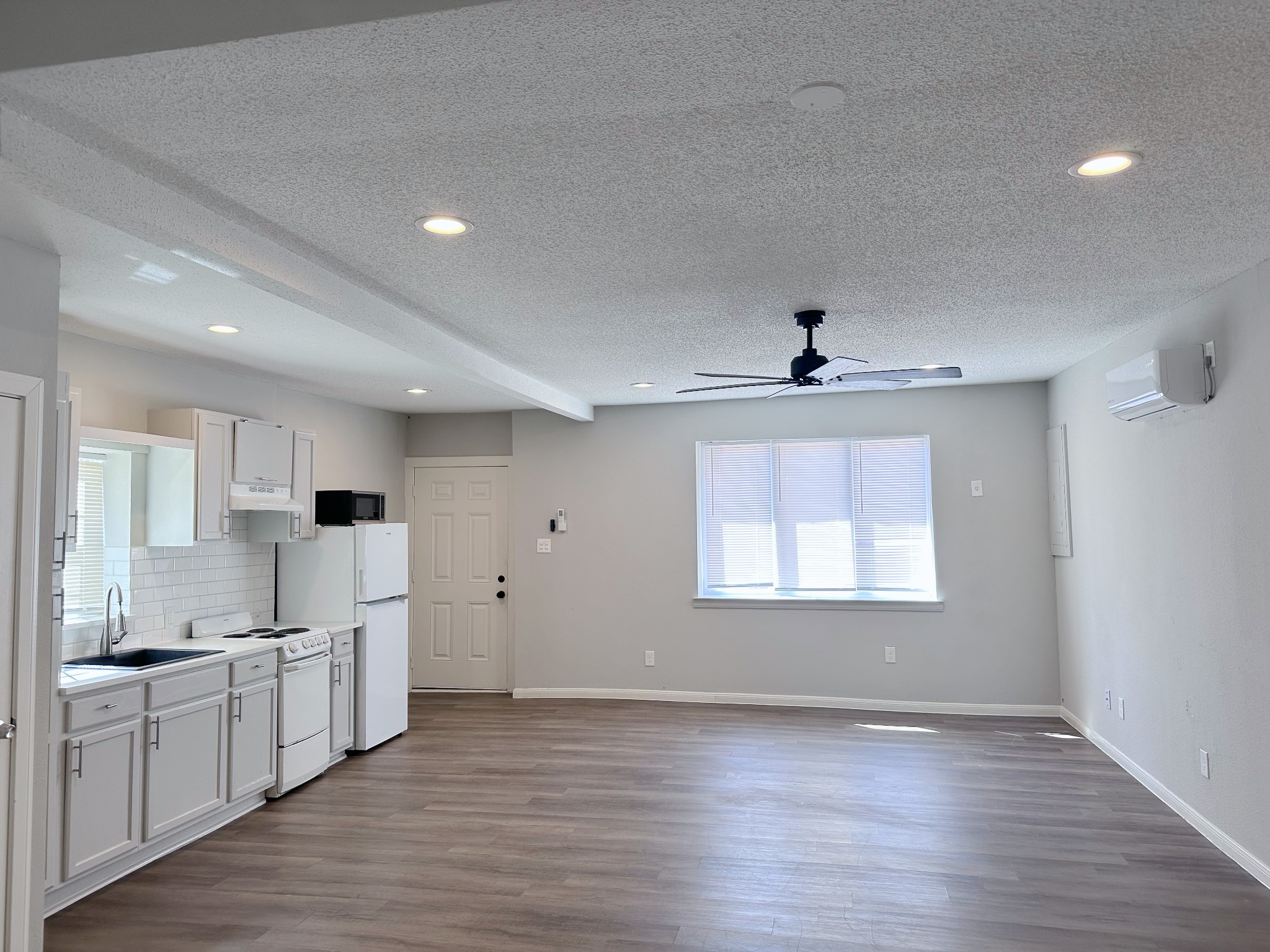2704 Brewster Street Houston, TX 77026 - Photo 7 of 10 a view of a kitchen with a sink and wooden floor
