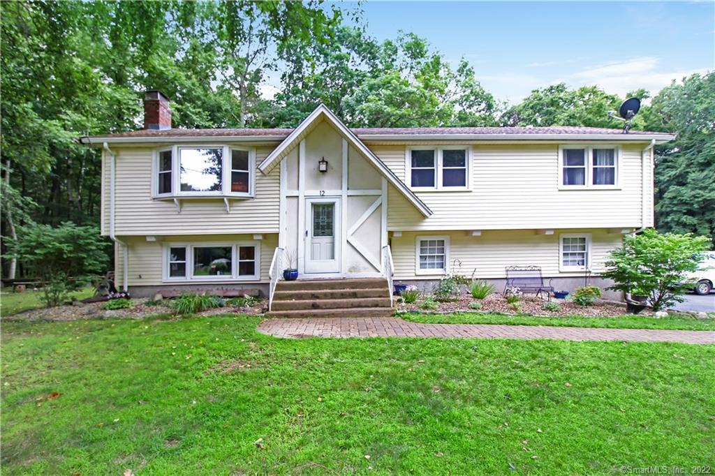 a front view of house with yard and outdoor seating