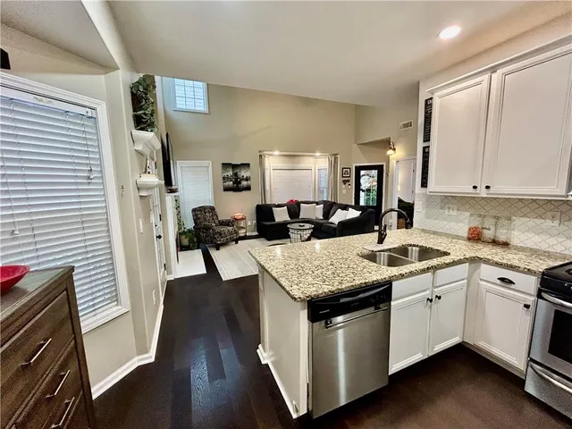 a kitchen with a sink stove and cabinets
