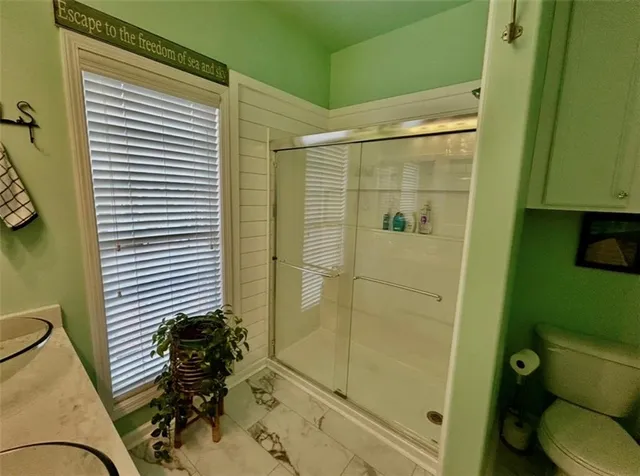 a bathroom with a shower and a toilet