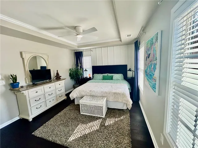 a bed room with furniture and a flat screen tv