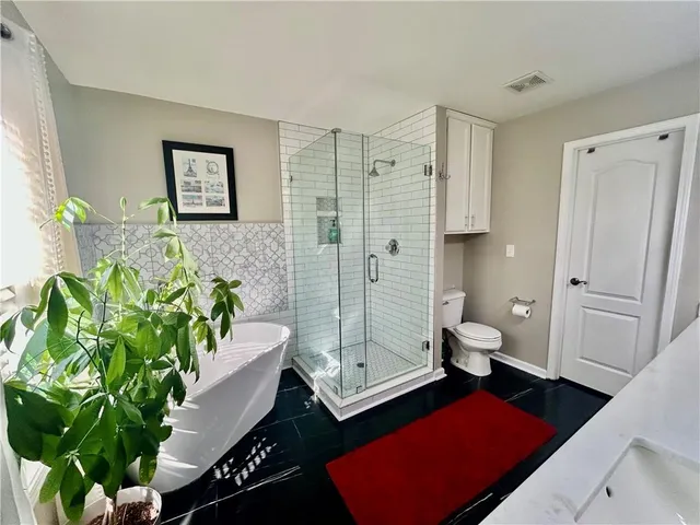 a bathroom with a toilet sink and shower
