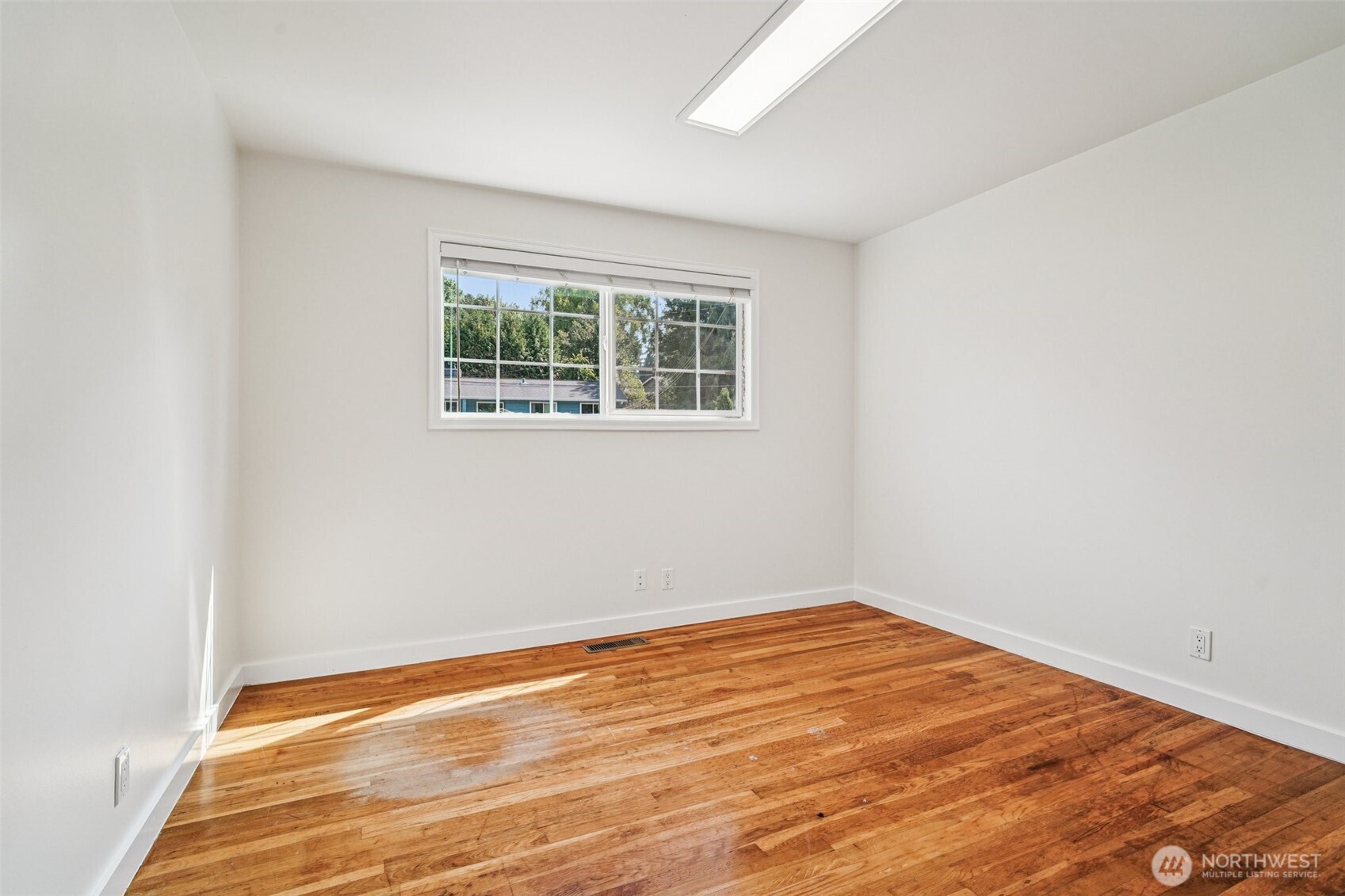 17841 4th Avenue Northwest Shoreline, WA 98177 - Photo 16 of 33 an empty room with wooden floor and a window