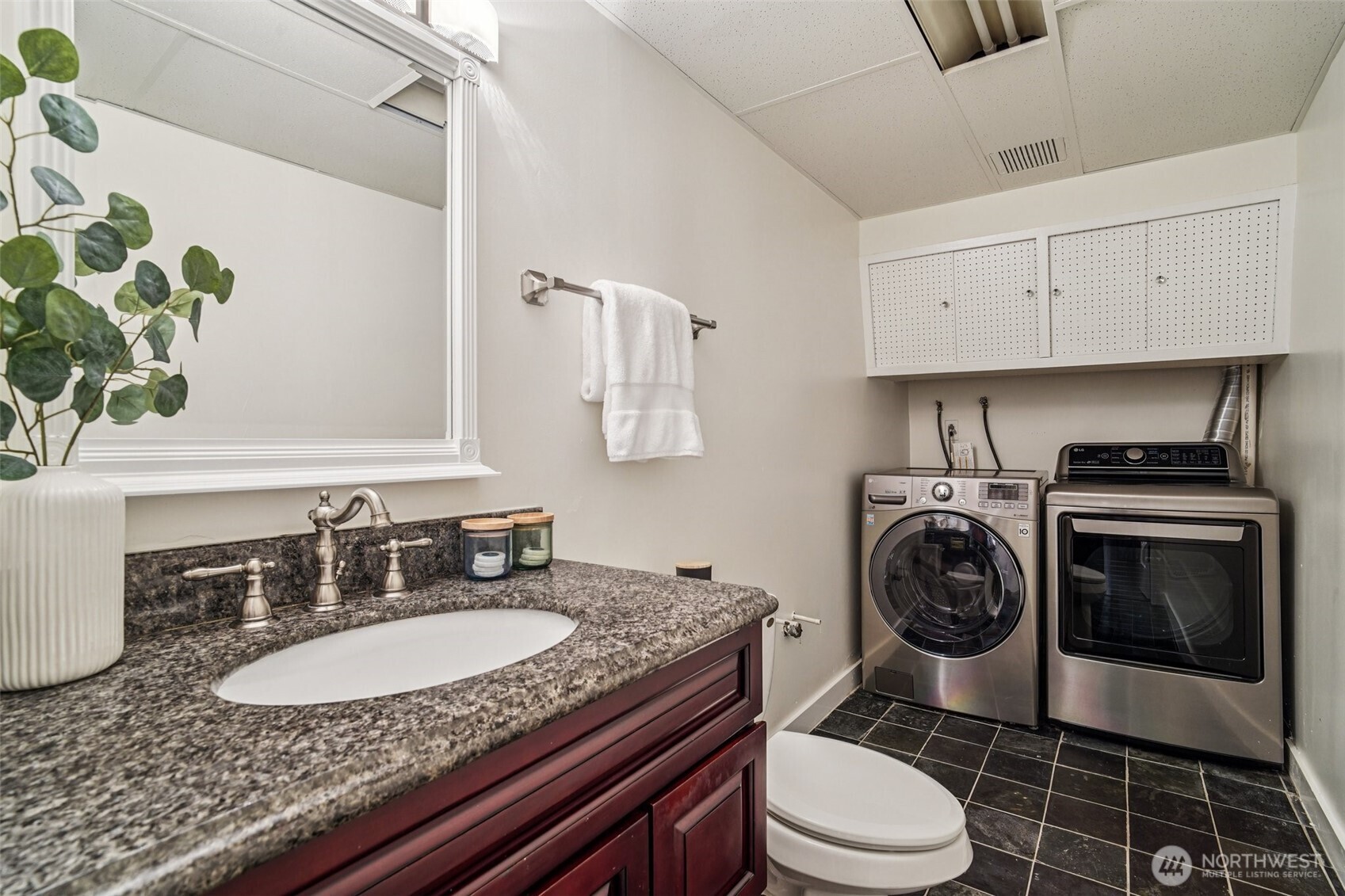 17841 4th Avenue Northwest Shoreline, WA 98177 - Photo 21 of 33 a bathroom with a granite countertop toilet sink and mirror