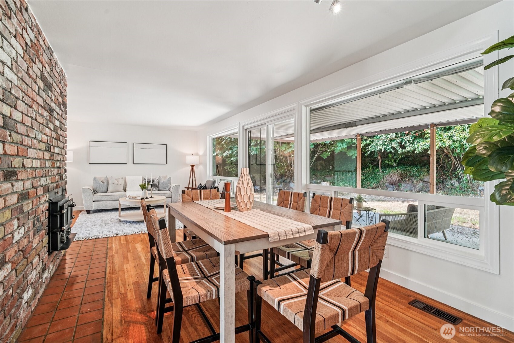 17841 4th Avenue Northwest Shoreline, WA 98177 - Photo 4 of 33 a view of a dining room with furniture large windows and wooden floor