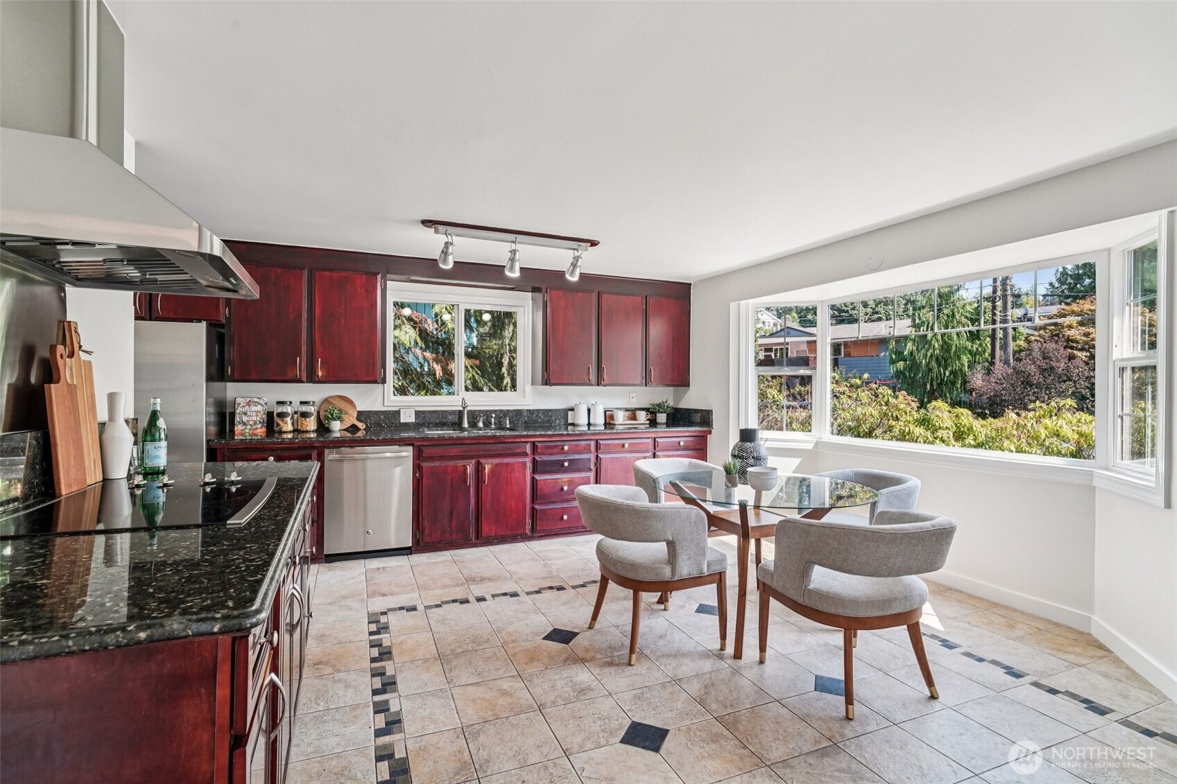 17841 4th Avenue Northwest Shoreline, WA 98177 - Photo 8 of 33 a kitchen with kitchen island granite countertop wooden cabinets and dining table