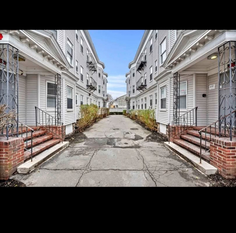 a view of a brick house with many windows