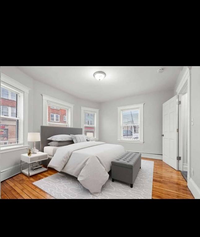 2 Kingsley Terrace, Unit 7 Lynn, MA 01902 - Photo 12 of 13 a living room with furniture and a flat screen tv