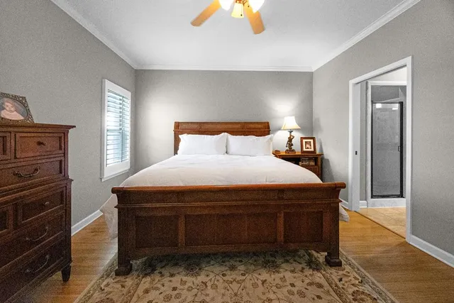 a bedroom with a bed and a dresser in it