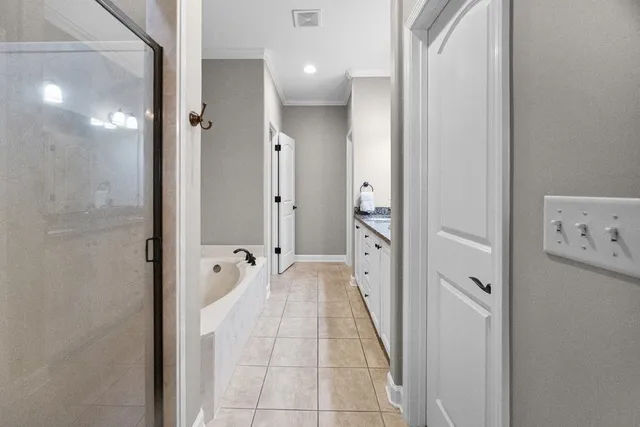 a bathroom with a tub and shower