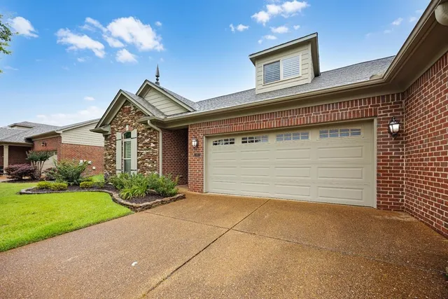 a view of a house with a yard and garage