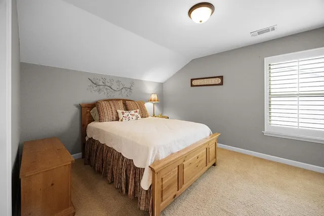 a bedroom with a bed and a lamp