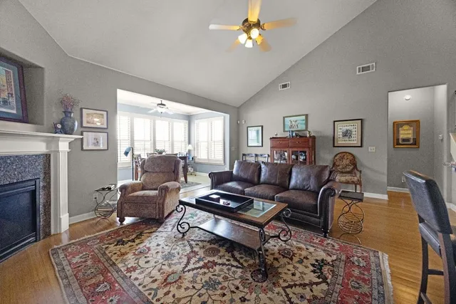 a living room with furniture a fireplace and a table