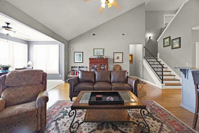 a living room with furniture and a wooden floor